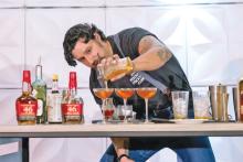 (GABRIEL BRISENO | CONTRIBUTED PHOTO) Gabriel Briseno, of Graham, goes up head to head with himself on the second day of competition at BourbonCon. Briseno won the mixologist competition on the first day and then prepared two cocktails for the audience to judge on the second day. 