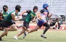 (ALEX HAVARDANSKY | THE GRAHAM LEADER) Parker Hale runs away from defenders to the endzone for a touchdown Saturday, May 24 against Benbrook in a 7on7 tournament. Hale erupted in the second half of that matchup with two scores on back to back drives. 