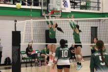 (ALEX HAVARDANSKY | THE GRAHAM LEADER) Aubree Clayton, left, and Kinzee Forbus, right, go up for a block Tuesday, Sept. 16, against the Gold-Burg Lady Bears. Both Clayton and Forbus shined in the Ladycats dominant three-set win. 