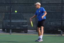 (ALEX HAVARDANKSY | THE GRAHAM LEADER) Brooklyn Tarsoaga takes a swing at a ball in a singles match. Tarsoaga fought hard in a 8-5 singles loss against Iowa Park. 