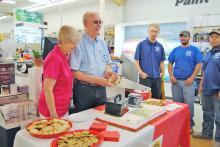 (GRAHAM CHAMBER OF COMMERCE | CONTRIBUTED PHOTO) Curtis and Geneva Buchanan cut a cake May 8, 2014 to celebrate 40 years of their business in Graham. The event was held with a ribbon cutting ceremony from the Graham Chamber of Commerce.