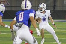 (ALEX HAVARDANSKY | THE GRAHAM LEADER) Jace Gill runs out of the pocket and away from multiple defenders Friday, Aug. 29. Gill was very effective picking up key first downs with his legs. 