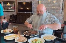 (BRICKHOUSE PIZZA & TAPROOM | CONTRIBUTED PHOTO) Olney resident Andrew Clinton digs into the Brickhouse Pizza & Taproom 56-ounce Prime Rib Challenge which he completed in March. Clinton has competed in challenges in the past, but was using this challenge as a way to kickstart his weight loss journey. 
