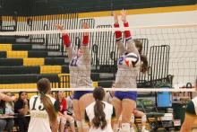 (ALEX HAVARDANKSY | THE GRAHAM LEADER) Landree Smith (left) and Collins Weil (right) go up for a block Tuesday, Aug. 26, against the Lady Jackets. Smith and Weil were putting in work at the front of the net defensively to keep the Lady Blues competing.