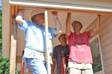 (ARCHIVE PHOTO | THE GRAHAM LEADER) Volunteers from Faith Center help Graham Habitat for Humanity build the 15th house for the organization in July 2019. Shown from left to right are Faith Center Pastor Gary Elrod, Richard Arellano and Shelby Oaks.