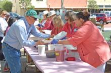 (FILE PHOTO | THE GRAHAM LEADER) Members of the Graham Regional Medical Center Auxiliary prepare chalupa meals during the Chalupa Luncheon held in 2022 on the Young County Courhouse lawn.