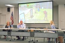 (THOMAS WALLNER | THE GRAHAM LEADER) The Graham ISD Board of Trustees watch a National Glazing Solutions demo video during their meeting Wednesday, April 19. The video demonstrated how adding film to a window can hold off a potential gunman trying to enter a building.