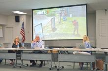 (FILE PHOTO | THE GRAHAM LEADER) The Graham ISD Board of Trustees watch a National Glazing Solutions demo video during their meeting Wednesday, April 19. The video demonstrated how adding film to a window can hold off a potential gunman trying to enter a building.