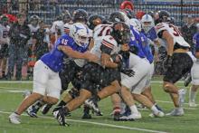 (ALEX HAVARDANKSY | THE GRAHAM LEADER) Denton Lauster makes a tackle in the backfield Friday, Sept. 5. Lauster is a senior defensive end on the team. 
