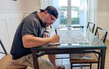 (BENJAMIN LEWIS | CONTRIBUTED PHOTO) Doodle artist Benjamin Lewis works on a piece at his home in Brenham. Lewis grew up in Graham and was commissioned to work on an art piece for Young County which helped him to reconnect with his hometown.