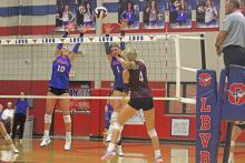 (ALEX HAVARDANKSY | THE GRAHAM LEADER) Emily Hughes, 10, and Katy McGehee, 1, go up for a block Tuesday, Sept. 23. The Lady Blues held their senior night match against the Brownwood Lady Lions this night.