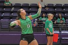 (ALEX HAVARDANSKY | THE GRAHAM LEADER) Emma Hawkins throws the ball up in the air for a serve in one of the Ladycats tournaments. Hawkins was a first team all district player for Newcastle and also an academic all-district nominee. 