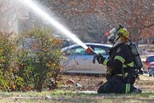 (THOMAS WALLNER | THE GRAHAM LEADER) A Graham Fire Department firefighter sprays water at a home on the corner of Plum and Second Street. GFD and other adjoining county fire departments received grants from the Texas A&M Forest Service in February for equipment and training aids.
