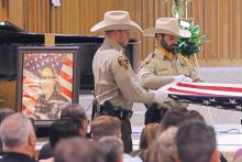 (THOMAS WALLNER | THE GRAHAM LEADER) Members of the Wichita County Honor Guard fold a flag that was presented Wednesday, Aug. 7 to the family of Olney Police Department Cpl. Miranda Wright. A memorial service was held to honor the life of Wright at First Baptist Church in Olney.