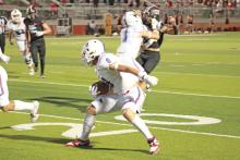 (TC GORDON | THE GRAHAM LEADER) Jace Gill carries the ball and attempts to evade Mineral Wells defenders during Graham’s 55-7 win Friday, Sept. 22 over the Rams. Graham remains undefeated on the season at 5-0 heading into homecoming week.