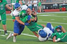 (TC GORDON | THE GRAHAM LEADER) Juniors Blake Bergeson (50) and Brycen Rogers (18) team up to sack the Iowa Park quarterback during Graham’s matchup Friday, Sept. 15 with Iowa Park. The Steers dominated the Hawks 67-6 and moved to 4-0 on the season.