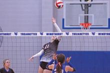 (TC GORDON | THE GRAHAM LEADER) Junior Lillian Noble (11) jumps up to softly hit the ball into the hole of the opposing defense in Graham’s match Friday, Sept. 15 against Windthorst. The Lady Blues swept the Trojanettes in three sets.