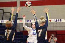 (TC GORDON | THE GRAHAM LEADER) Junior Lillian Noble (11) hits a ball through two Stephenville defenders during Graham’s district match Friday, Oct. 6 against the Honeybees. The Lady Blues lost in four sets and moved to 2-2 in district play.
