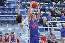 (THOMAS WALLNER | THE GRAHAM LEADER) Thomason Burkett jumps to attempt a shot over a Brock defender during the Steers district opener Saturday, Jan. 11. The game was moved to Saturday after school was canceled due to inclement weather.