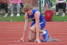 (TC GORDON | THE GRAHAM LEADER) Graham’s Thomason Burkett sets his feet on the blocks and watches the starter before the 400-meter Dash Monday, April 1 at the District 6-4A track meet in Mineral Wells.
