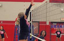 (ALEX HAVARDANSKY | THE GRAHAM LEADER) Multiple Lady Blues go up for a block attempt in their opening game Monday, June 23. The Lady Blues picked up multiple dominant wins on the night.