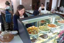 (THOMAS WALLNER | THE GRAHAM LEADER) Owner of Olivet & Oak, Eleanor Burkett, stocks fresh servings at the new lunch destination at 526 Oak St. The location offers sandwiches, salad and fresh goods baked daily.