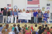 (THOMAS WALLNER | THE GRAHAM LEADER) Members of the Graham Public Education Foundation presents a grant Friday, April 11 in the amount of $9,899.75 to teachers of Pioneer Elementary School.