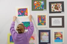 (THOMAS WALLNER | THE GRAHAM LEADER) Students from Graham High School helped put up artwork from Graham ISD, Jacksboro ISD, Bryson ISD and Archer City ISD at the Old Post Office Museum and Art Center.