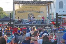 (ARCHIVE PHOTO | THE GRAHAM LEADER) Sean McConnell plays for a crowd of listeners at the Summer Concert Series on the Graham downtown square in 2024. His performance and a fireworks show closed out a day of Fourth of July events in Graham.