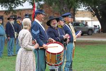(ARCHIVE PHOTO | THE GRAHAM LEADER) Living history reenactors share a laugh before the flag ceremony at the Fort Belknap Days education event in 2023. The living history event is split up into an education day for students and a public day open to everyone.
