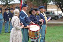 (ARCHIVE PHOTO | THE GRAHAM LEADER) Living history reenactors share a laugh before the flag ceremony at the Fort Belknap Days education event in 2023. The living history event is split up into an education day for students and a public day open to everyone.