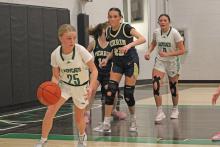 (ALEX HAVARDANKSY | THE GRAHAM LEADER) Allison Melton dribbles the ball out to the three point line Tuesday, Jan. 13 against the Perrin-Whitt Lady Pirates. With this win the Ladycats moved to 2-0 in district play. 