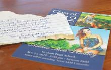 (THOMAS WALLNER | THE GRAHAM LEADER) A note found hidden behind a mirror by Dana Lindley while doing bathroom renovations. The note was from his daughter Amber who passed away in July 2012. Next to the note is a Class of 2012 Graham High School graduation ceremony invitation for Amber.