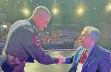 (DAVID LIPSEY | CONTRIBUTED PHOTO) Graham Police Department K-9 Officer David Lipsey shakes hands with Gov. Greg Abbott while being presented the Star of Texas Award in Austin. The award honors peace officers, firefighters and emergency medical first responders who made commitments while performing their duties.