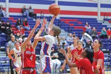 (ARCHIVE PHOTO | THE GRAHAM LEADER) Katy McGehee of the Lady Blues jumps over Mineral Wells defenders as she attempts a shot Friday, Jan. 17.