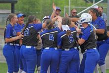 (ALEX HAVARDANSKY | THE GRAHAM LEADER) The Lady Blues celebrate after Zoey Harrell’s walk off home run Friday, April 18. The team’s win over the Mineral Wells Lady Rams would send them to the postseason.