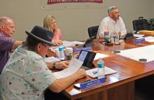 (ARCHIVE PHOTO | THE GRAHAM LEADER) Members of the Graham City Council examine the proposed budget in July 2024 for fiscal year 2024-2025. The council will be receiving a recommendation in the future for engineering services for a wastewater project.