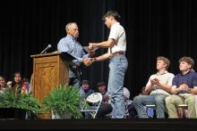 (THOMAS WALLNER | THE GRAHAM LEADER) Dana Lindley presents the Amber Lindley Memorial Scholarship to Brayden Riggins during the 39th annual Graham High School Scholarship Awards Ceremony held Monday, April 28.