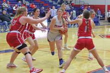 (THOMAS WALLNER | THE GRAHAM LEADER) Briley Randall pushes her way through a trio of Glen Rose defenders Friday, Jan. 24 as she attempts to set up a shot at the basket. Despite a late-game attempt by the Lady Blues to push ahead, the team fell 35-57.