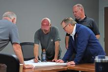 (THOMAS WALLNER | THE GRAHAM LEADER) City Manager Eric Garretty, Airport Board Chair Steve Pierce, Airport Manager Jon Delamarter and Perry Havenar with Centurion Planning & Design speak before a public meeting regarding planning the future of the Graham Municipal Airport.