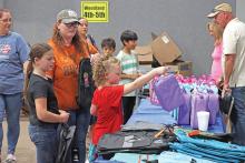 (ARCHIVE PHOTO | THE GRAHAM LEADER) A visitor to Graham Up Graham in 2024 picks out a lunch bag to use for the new school year. The annual event distributes school supplies and other necessities for students at no charge.