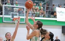 (THOMAS WALLNER | THE GRAHAM LEADER) Ladycat Mattie Dollar jumps to make a shot at the net as she continues to be a force for the Newcastle team each game. Dollar scored 24 points for the team, almost half of the points made during the game.
