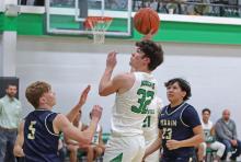 (THOMAS WALLNER | THE GRAHAM LEADER) Cooper Clayton attempts a shot at the net over Perrin defenders during the game Friday, Jan. 24. The Bobcats will travel Tuesday, Jan. 28 to Bryson and will make another trip Friday, Jan. 31 when they go up against Garner. 