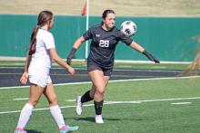 (ARCHIVE PHOTO | THE GRAHAM LEADER) Taylor Lauster clears the ball for Graham in their 2025 area playoff matchup against the Lubbock Cooper Liberty Lady Patriots. Lauster will be a returning starter for the team and veteran leader this year. 