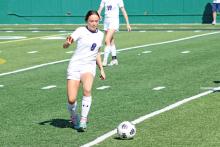 (ALEX HAVARDANSKY | THE GRAHAM LEADER) Kinsley Amburn attempts to clear the ball out of Graham’s zone and away from the Lubbock Liberty Lady Patriots in the first half of their match Tuesday, March 25. The Lady Blues were pressured early by the Lady Patriots.