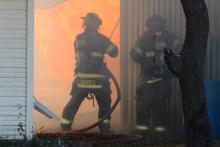 (ARCHIVE PHOTO | THE GRAHAM LEADER) Graham Fire Department fights a fire near the South Allsups in April 2022 that was threatening an oil tank. GFD and Olney Volunteer Fire Department will be receiving funding from the Rural Volunteer Fire Department Assistance Program with Texas A&M Forest Service.