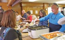 (ARCHIVE PHOTO | THE GRAHAM LEADER) Volunteers hand out food at the Bethel Baptist Church community Thanksgiving meal in 2023. The annual tradition invites all to the church facility to share in a Thanksgiving meal at no charge.