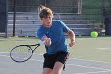 (ALEX HAVARDANSKY | THE GRAHAM LEADER) Tyler Bryan takes a shorthanded swing Wednesday, July 30, in a practice match. Bryan won a spot in the top three for the Steers tennis team with his performances during practices.