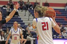 (ALEX HAVARDANSKY | THE GRAHAM LEADER) Bentleigh Martin looks to pass the ball to a teammate Tuesday, Jan. 20 against the Brownwood Lady Lions. The Lady Blues played their first home game in district play against the Lady Lions.