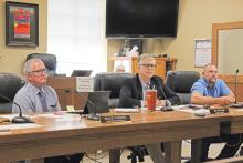 (TC GORDON | THE GRAHAM LEADER) Young County Judge Win Graham (middle), commissioner Stacey Rogers (left) and commissioner Scott Shook (right) listen to a presentation at a commissioners court meeting Monday, June 10. The commissioners recently presented a proposed budget and will have a public hearing on the budget and tax rate for the coming fiscal year at 9:30 a.m. Monday, Aug. 26.